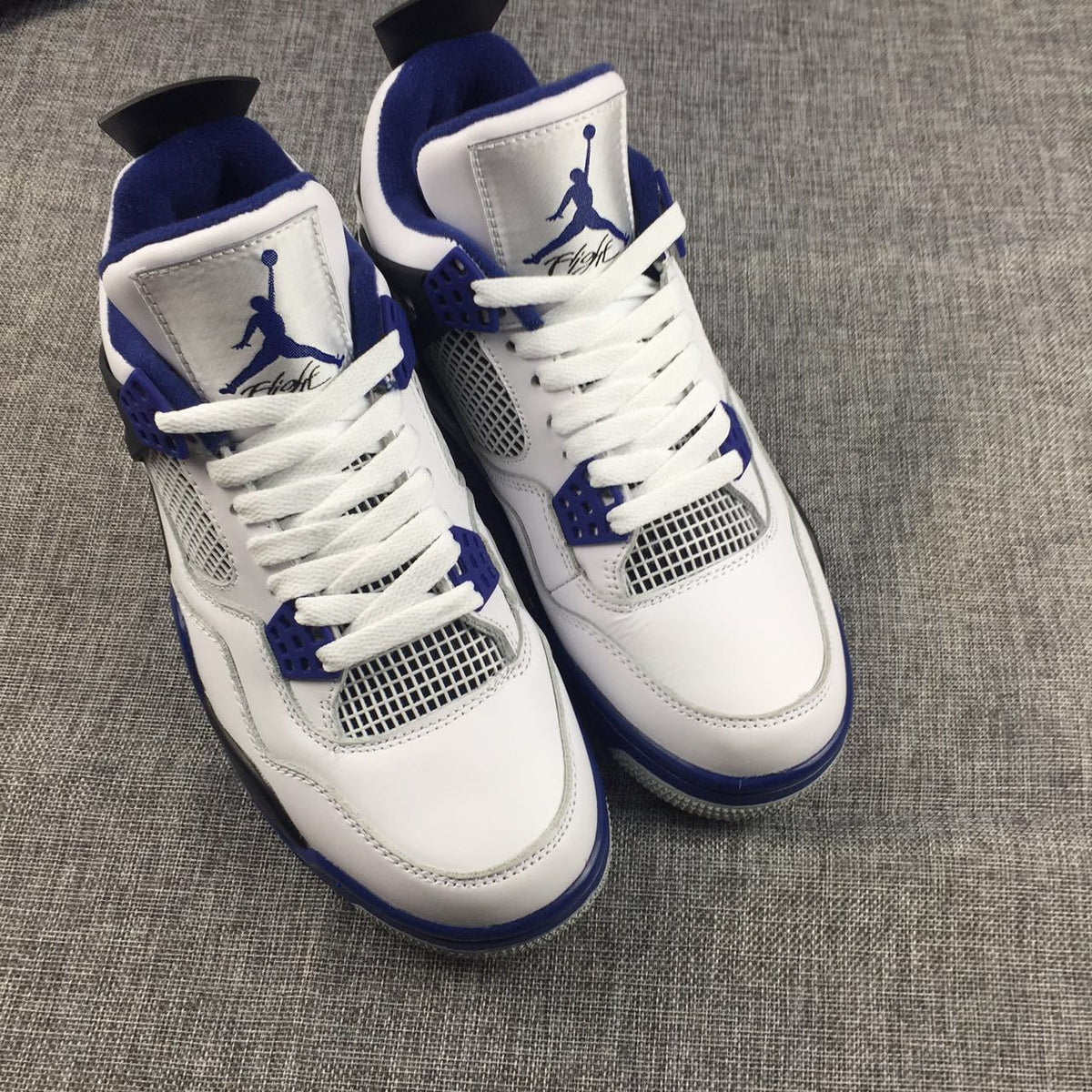 Jordan Air Jordan 4 Sneakers in White, Black and Blue